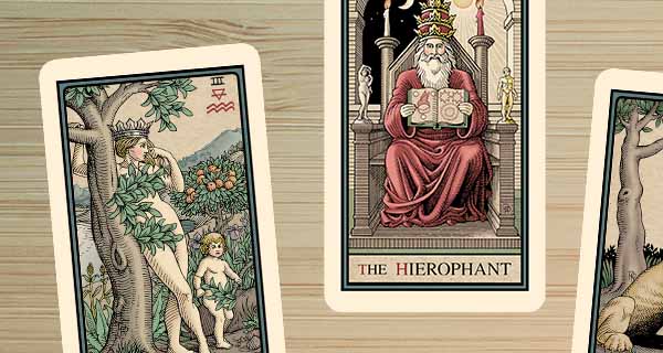 An image of Tarot cards on a table. The middle card is the Hierophant, while the names of the other two cards are cut off.