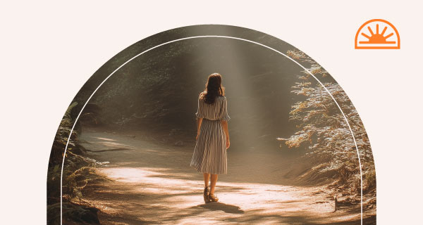A woman wandering through the woods.