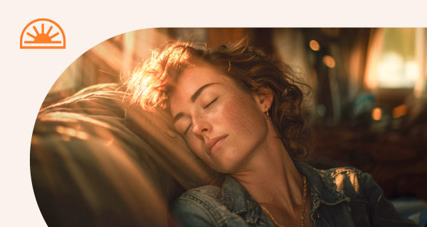 A woman napping as the sun sets.